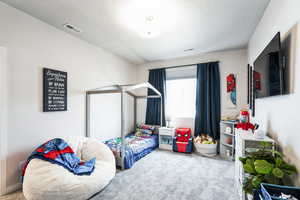 Bedroom featuring visible vents and carpet