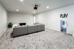 Carpeted cinema with visible vents, recessed lighting, and baseboards