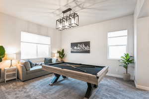 Playroom with pool table, carpet, and baseboards