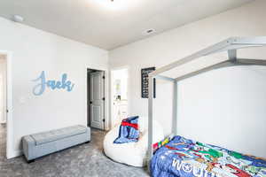 Bedroom featuring visible vents and carpet