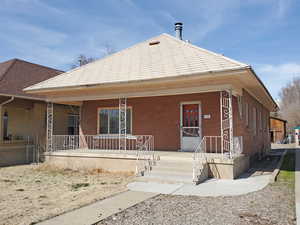 Bungalow-style house featuring brick siding and covered porch