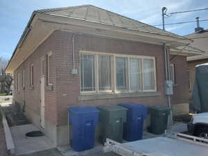 View of property exterior with brick siding