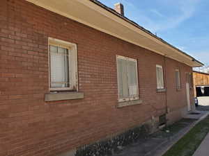 View of home's exterior featuring brick siding and crawl space