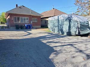 Back of house with a shingled roof