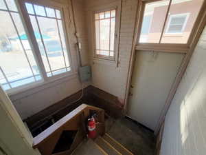 Doorway to outside with a healthy amount of sunlight and brick wall