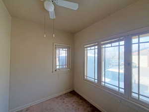 Unfurnished room with baseboards, carpet floors, and ceiling fan