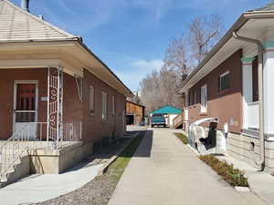 View of property exterior featuring concrete driveway and brick siding