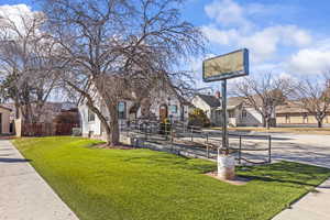 Surrounding community featuring a residential view, a lawn, and fence