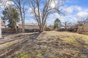 View of yard featuring fence
