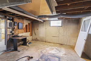 Basement featuring electric panel and water heater