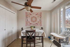 Dining room featuring light tile patterned floors and visible vents