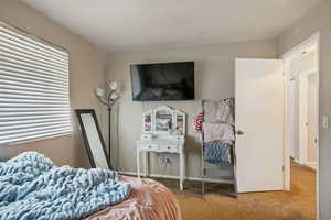 Carpeted bedroom with baseboards