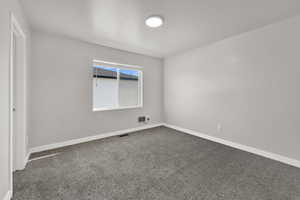 Bedroom #1 featuring carpet floors, a walk in closet, and a textured ceiling