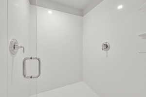 Master Bathroom Walk-in shower with multiple shower heads, shower door and recessed lighting
