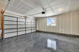 Garage with coated flooring and a garage door opener
