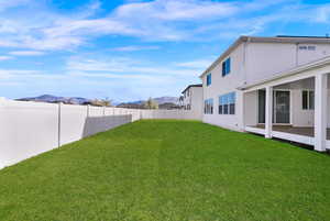 Fenced backyard with a mountain view