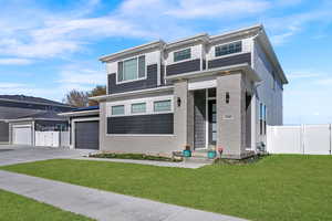 View of front of home featuring a gate and concrete driveway