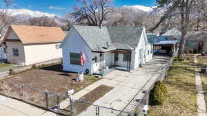 View of front of property with a mountain view, a fenced front yard, and a gate