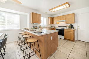Open Kitchen with Breakfast Bar and Tile Flooring
