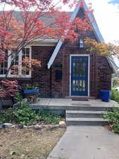 View of exterior entry with brick siding