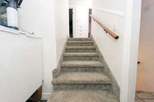 Stairs featuring tile patterned flooring