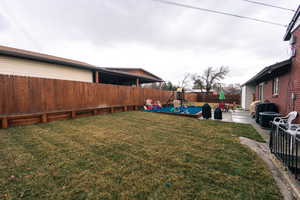 View of yard with a patio area, a playground, and a fenced backyard