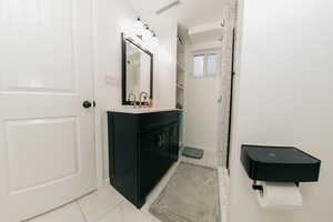 Full bath with marble finish floor, visible vents, and vanity