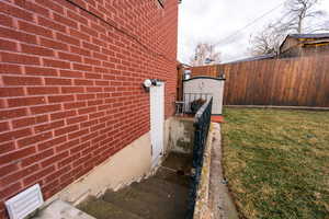 View of home's exterior featuring fence and brick siding