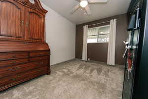 Unfurnished bedroom featuring light carpet and a ceiling fan