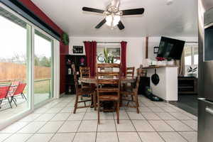 Dining room with light tile patterned floors and a ceiling fan