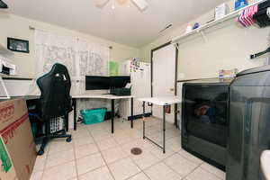 Interior space featuring laundry area, visible vents, and a ceiling fan