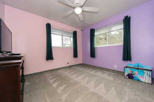 Empty room with carpet and a ceiling fan