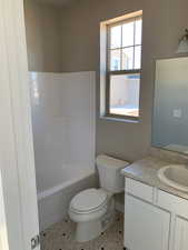 Bathroom with tile patterned floors, toilet, and vanity