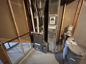 Utility room featuring heating unit