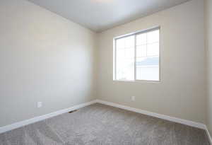 Unfurnished room with visible vents, baseboards, and carpet floors