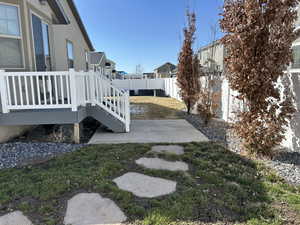 View of yard featuring a patio, a wooden deck, and a fenced backyard