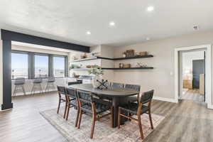 Dining room featuring recessed lighting, baseboards, visible vents, and light wood finished floors