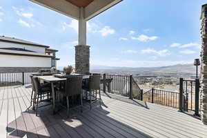 Deck featuring outdoor dining area and a mountain view