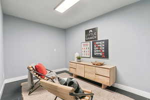 Sitting room with dark tile patterned floors and baseboards