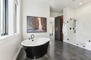 Full bath featuring baseboards, a freestanding tub, recessed lighting, a shower stall, and tile patterned floors