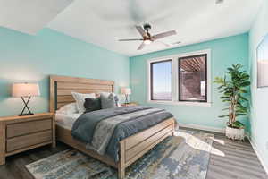 Bedroom featuring ceiling fan, baseboards, and wood finished floors