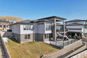 Rear view of house with a patio, a fenced backyard, stucco siding, central air condition unit, and a lawn