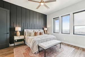 Bedroom with light wood-style flooring, visible vents, baseboards, and ceiling fan
