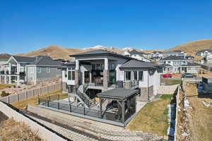 Back of property with a residential view, a mountain view, a patio, and a fenced backyard