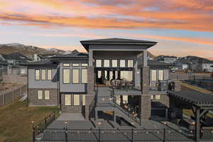 Back of property with stucco siding, a yard, a fenced backyard, and a patio area