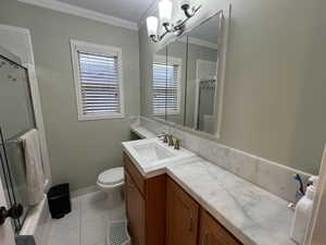 Bathroom main floor - featuring classic upgraded vanity and tile, crown molding