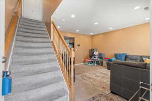 Stairway with baseboards, visible vents, carpet flooring, and recessed lighting