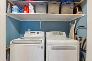 Washroom with laundry area and washer and dryer