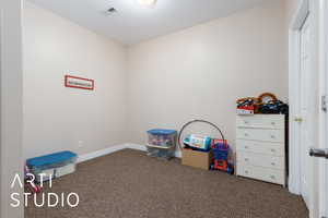 Recreation room with carpet flooring, baseboards, and visible vents