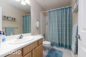 Full bath featuring visible vents, shower / bath combo with shower curtain, toilet, tile patterned flooring, and vanity